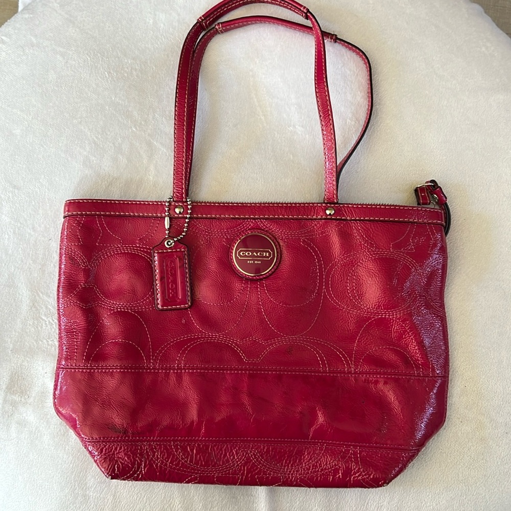 Coach pink leather bag with shoulder straps has rubs
